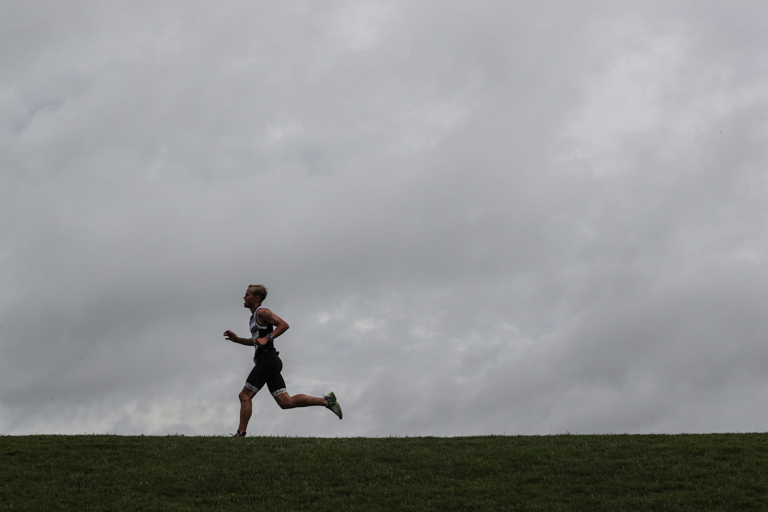 A runner pushes along the final stretch of the course during the 2019 Memphis in May triathlon at Edmund Orgill Park in Millington on Sunday, May 19, 2019. Jordan Green and Kirsten Sass were the winners of the annual triathlon.