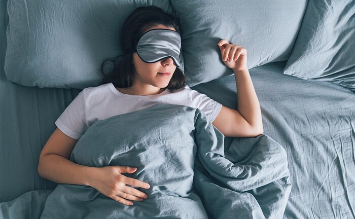 Sleeping with an eyeshade. 